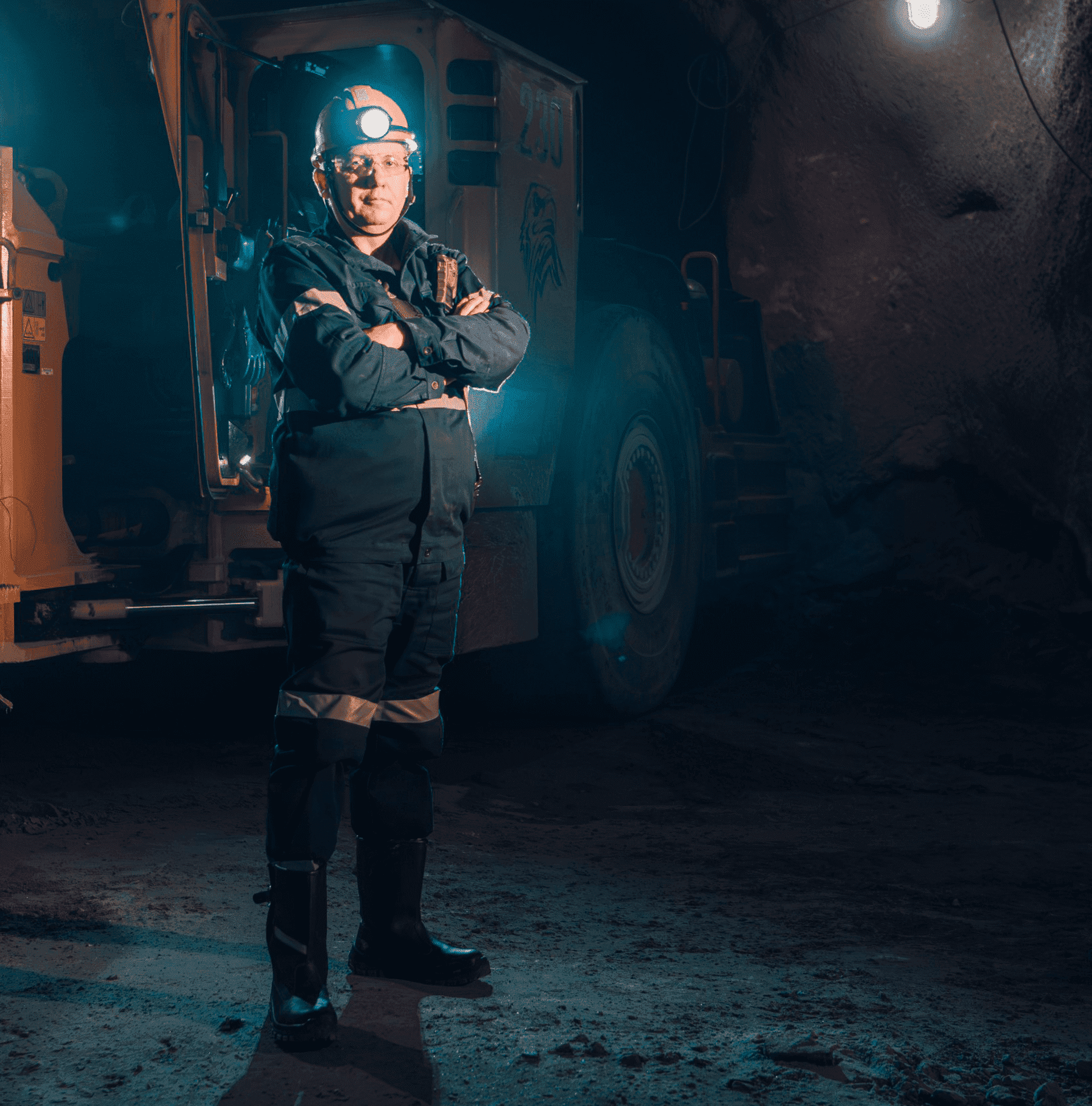 Worker in the dark with a flashlight on his helmet